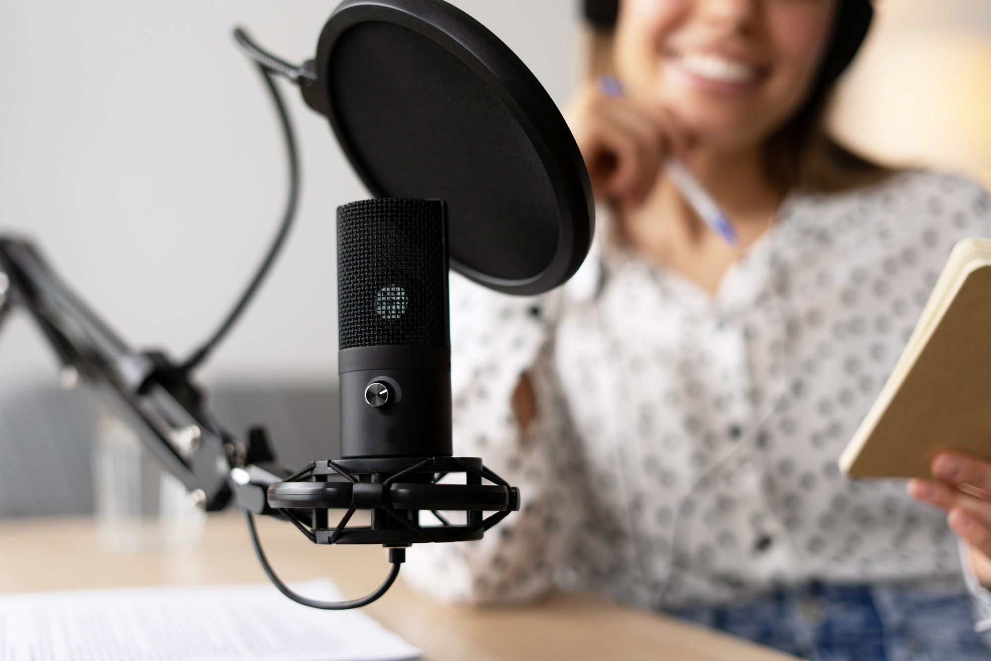 Professional Podcaster Recording Audio Content with Modern Microphone